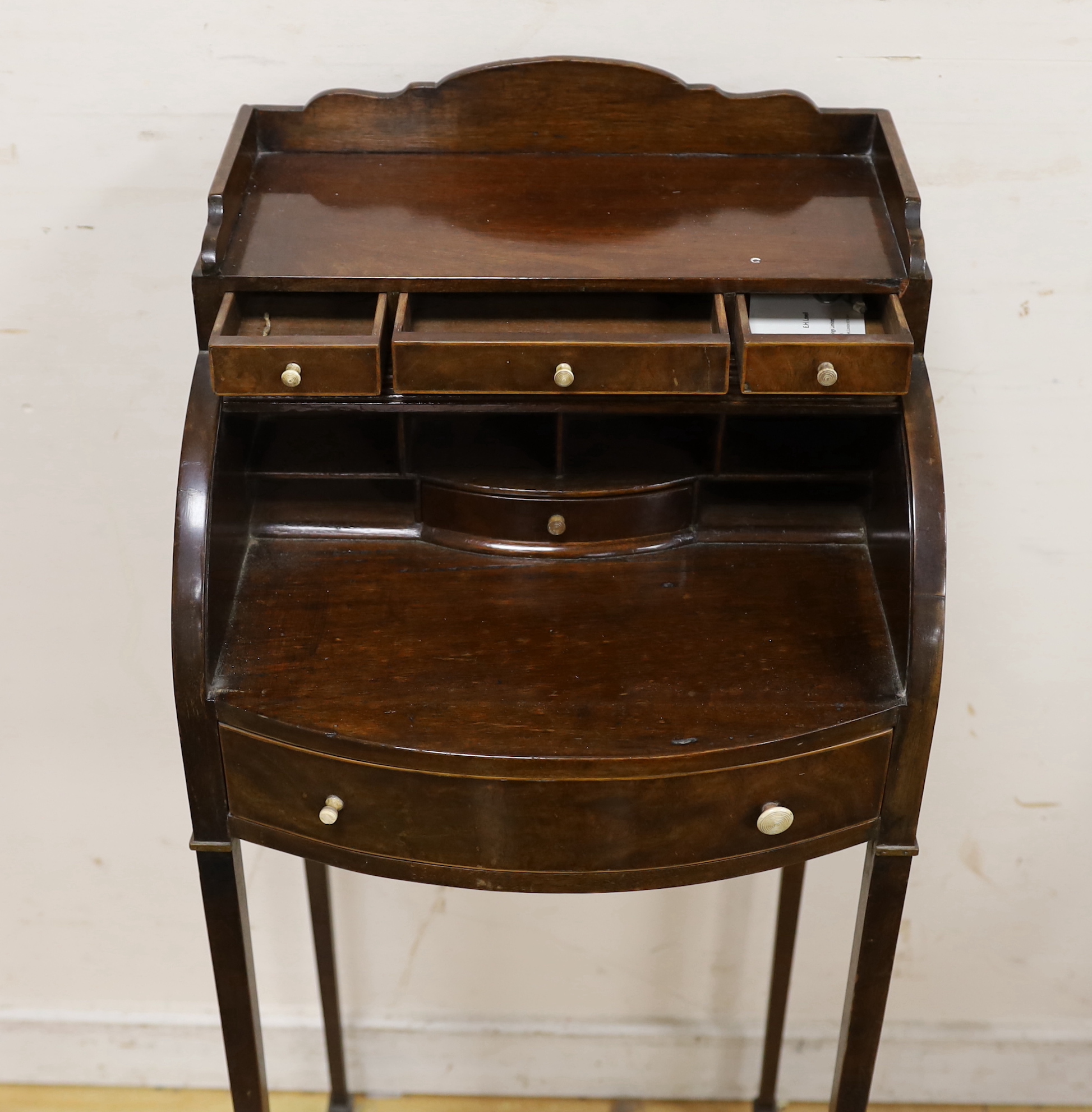 A small Edwardian mahogany Sheraton Revival bowfront tambour desk, width 38cm, depth 35cm, height 95cm